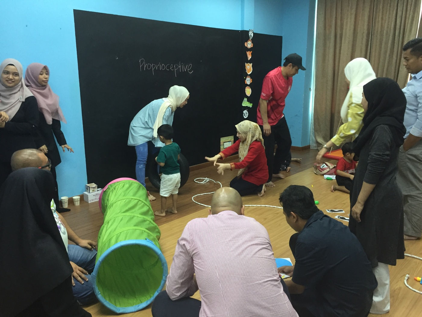 Parents working on home activities during the parenting class